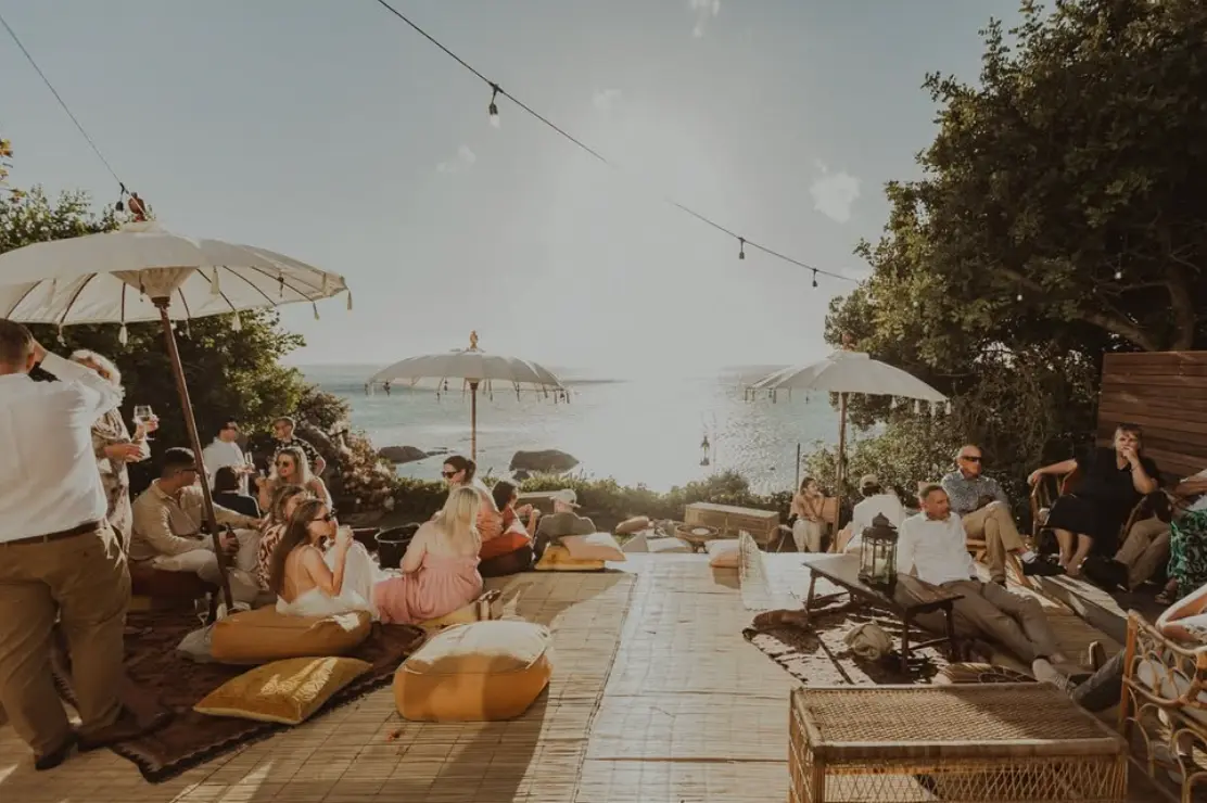 Guests gathering in a relaxed seaside wedding lounge by The Souk